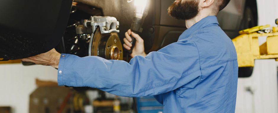 man working on car brakes